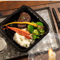 Pactiv Evergreen - 10.5" X 9.5" x 3.1" Black/Clear Vented Dual-Color PP Hinged Lid Container, 132 Count - DC109100B000